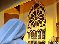 Woman praying in Nigerian church